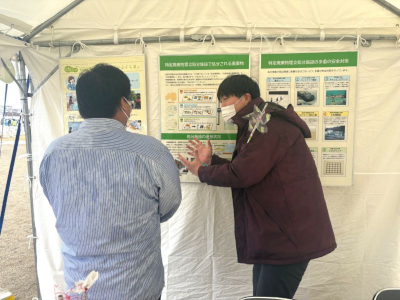 スタッフが来場者に説明している写真