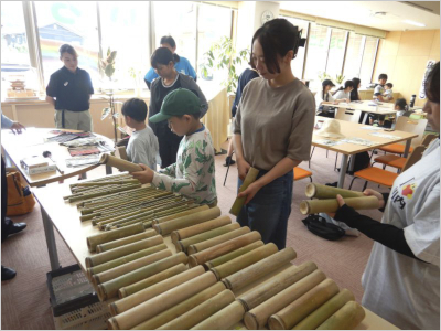 竹の筒から、材料を選ぶ参加者の様子