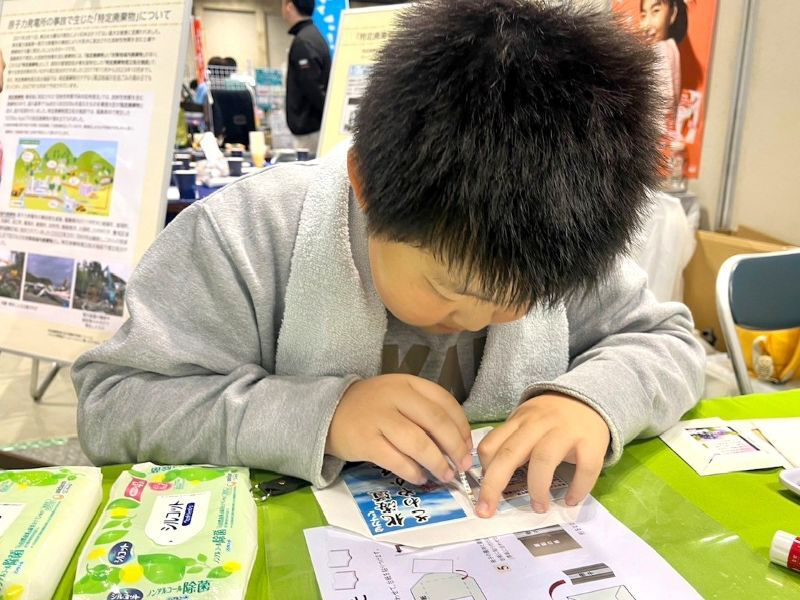 アップサイクルメモ帳を工作している子供の様子